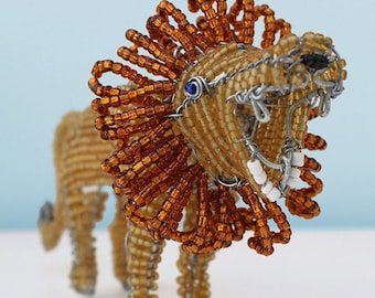 Beaded African lion on the hunt: The wild mane is captured in browns, reds and black to provide a contrast for the sleek golden body