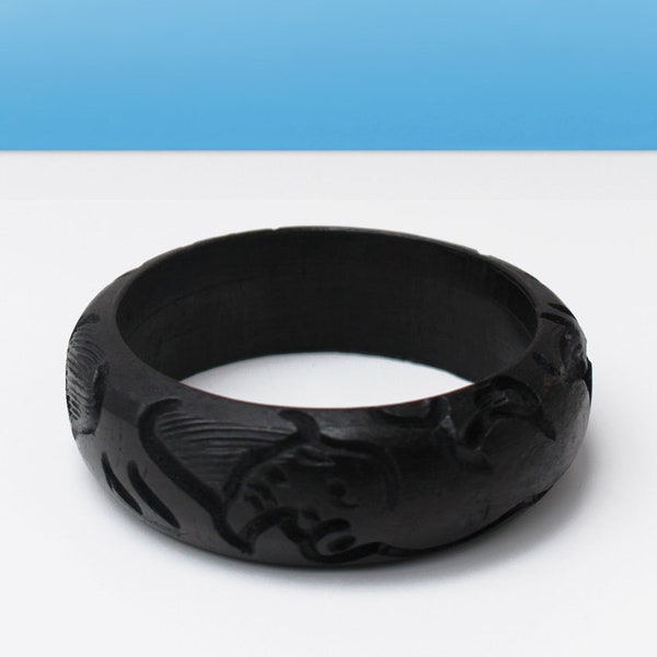 Ebony bangle: Solid African ebony this beautiful bangle has been carefully carved to give a detailed relief pattern.