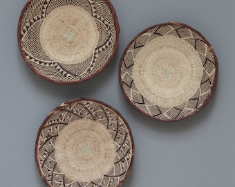 Choose from 2 sets Tonga baskets 34-36cm: Contrasting brown and cream vines and palm leaves are woven together to create patterns