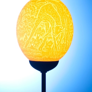 Giraffe and Africa themed ostrich egg lamp: An ostrich egg with the African continent on the back and two elegant giraffes on the front.