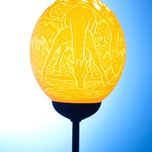 Giraffe themed ostrich egg lamp: gangly giraffe handcarved on ostrich eggshell set on a metal lamp stand. perfect for Mothers Day or gift