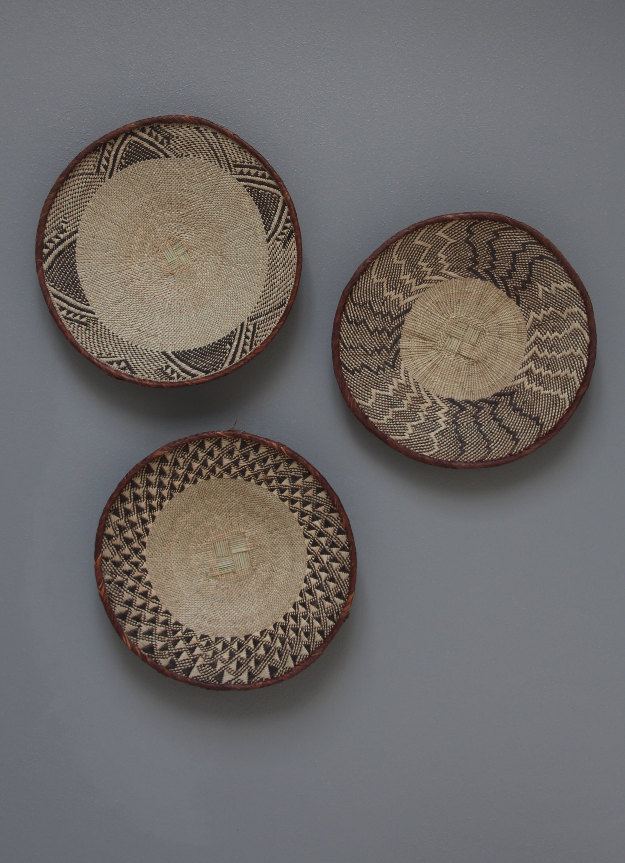 Tonga baskets: 41cm,42cm,41cm.Contrasting brown and cream palm leaves are woven together to create a geometric pattern