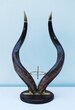 Kudu horn stand: Beautifully created from polished kudu horn, these impressive horns are balanced on a wooden base with brass fixtures 