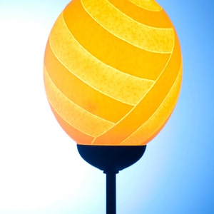 Teardrop themed ostrich egg lamp: the perfect shape of a teardrop is carved on an ostrich eggshell supplied with a metal lamp stand