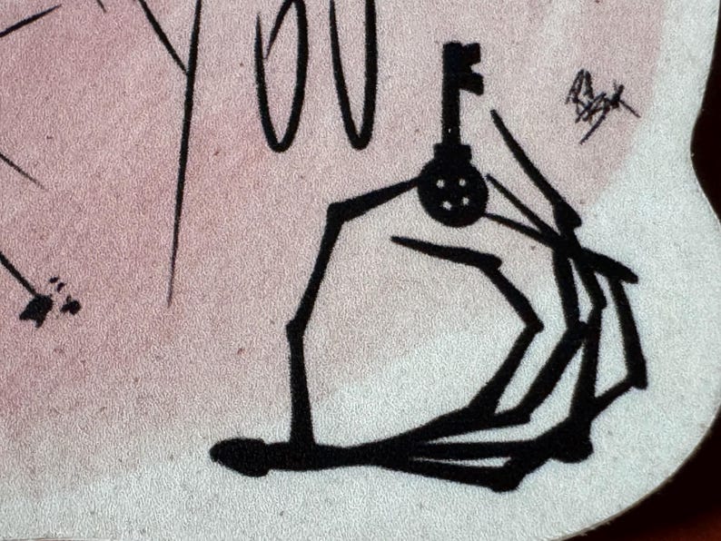 May include: Black and white line drawing of a hand holding a key. The hand is stylized and appears to be reaching out.