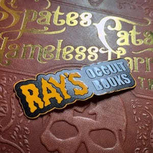 Präglat klistermärke med Rays ockulta böcker