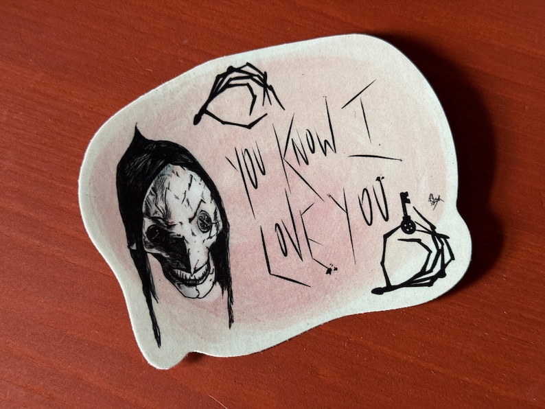 May include: A sticker with a black and white illustration of a creature with a long, pointed nose and large eyes. The creature is wearing a black hood. The sticker also features the text "You know I love you" in black ink on a pink background.