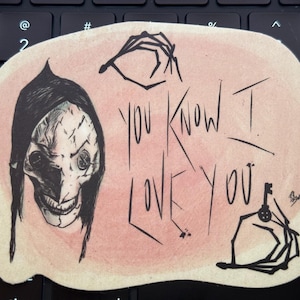 May include: A pink and white sticker with a black and white illustration of a creepy character with a stitched face and the text "You know I love you".