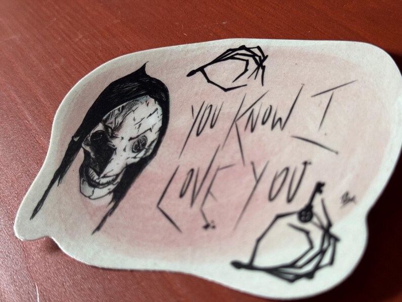 May include: A sticker with a black and white illustration of a person with a skull-like face and the text "You Know I Love You".