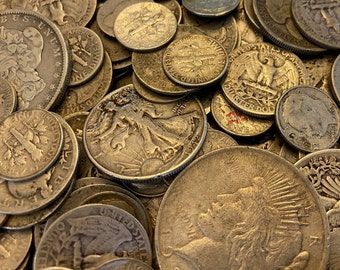 May include: A close-up of a pile of silver US coins, including a Walking Liberty Half Dollar, a Mercury Dime, and a Liberty Head Nickel. The coins are arranged in a random pattern, with some overlapping.