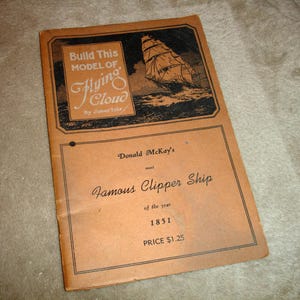 May include: Vintage model kit titled "Build This Model of Flying Cloud" by James Tate. The cover features an illustration of a clipper ship at sea. The kit is from 1851 and priced at $1.25.