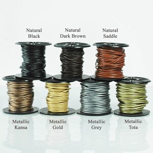 May include: A selection of leather cord spools in shades like natural black, dark brown, and saddle. Metallic colours include Kansa, gold, grey, and Tota. Each spool is clearly labelled with its colour name.