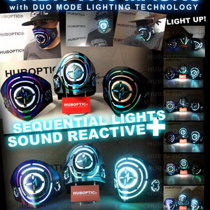 May include: A futuristic light-up face mask with a circular design featuring a blue, green, and white light pattern. The mask has two modes: random lighting and sound reactive lighting. The text "HUBOPTIC&reg;" is displayed on the mask and in the background. The text "ORBIT-X16 MASKS" is displayed at the top of the image. The text "SEQUENTIAL LIGHTS SOUND REACTIVE+" is displayed in the center of the image. The text "2 IN 1 One of a Kind! Futuristic Light Up Mask design by Jorge Pong" is displayed at the bottom of the image.