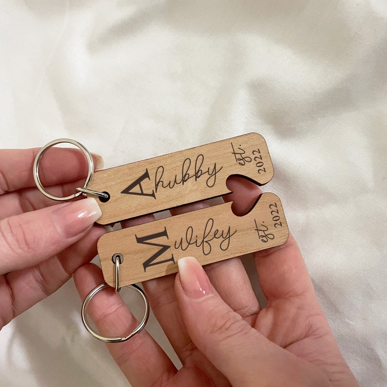 pair of wooden keyrings with silver keychain fitting. Engraved with custom inital for hubby and wifey with custom year engraved. Husband and wife gift for wedding