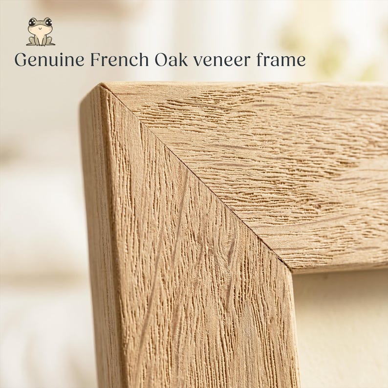 May include: Close-up of a light brown, textured, wooden picture frame corner. The frame is made of genuine French oak veneer. The text "Genuine French Oak veneer frame" is printed in black above the frame.