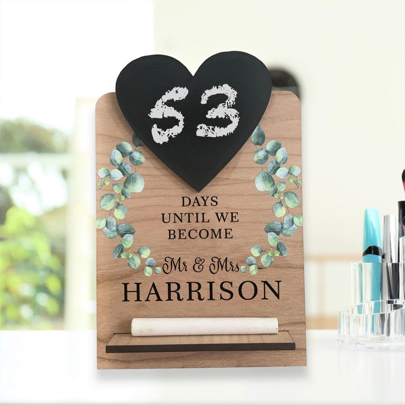 wooden engagement countdown to wedding, with eucalyptus design. personalised printing with mr and mrs to be name. heart shape chalk board