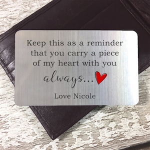 May include: A silver metal wallet insert with the text "Keep this as a reminder that you carry a piece of my heart with you always... Love Nicole" and a red heart.