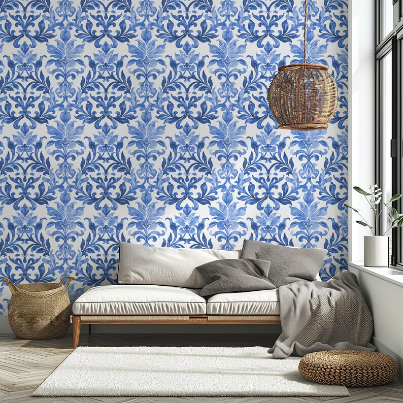 May include: Wallpaper featuring a repeating blue and white damask pattern with intricate floral and leaf motifs. The design covers the entire wall surface, showcasing a symmetrical, ornate style with varying shades of blue watercolor-like ink.