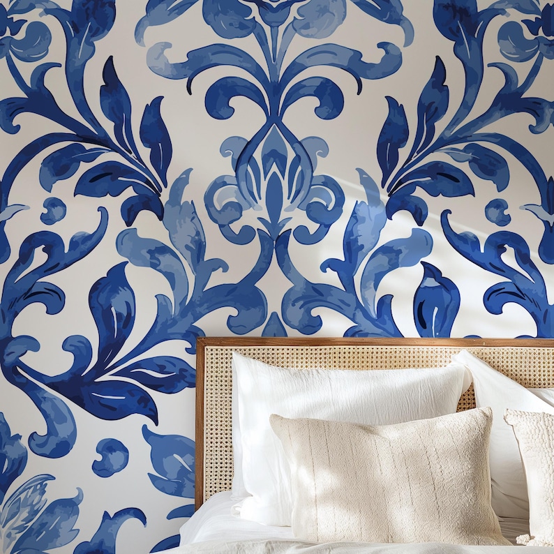 May include: Wallpaper featuring a repeating damask pattern in shades of deep blue and light blue on a white background. The design consists of symmetrical, flowing floral and leaf motifs that create a continuous, intricate visual texture.