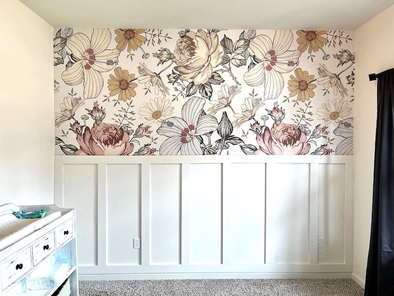 May include: A white wall with white wainscoting and a floral wallpaper featuring pink, brown, and white flowers.