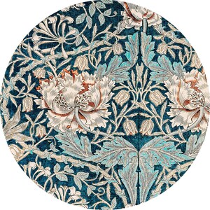 May include: Circular rug with a detailed floral pattern. The design features large, stylized flowers in cream and rust, set against a deep teal background. The leaves and vines are in shades of teal and cream, creating a symmetrical, ornate design.