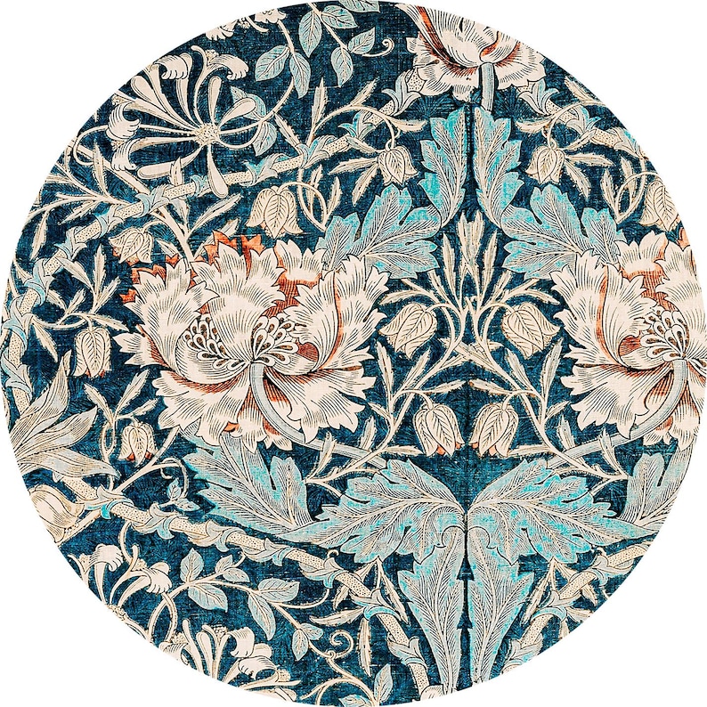 May include: Circular rug with a detailed floral pattern. The design features large, stylized flowers in cream and rust, set against a deep teal background. The leaves and vines are in shades of teal and cream, creating a symmetrical, ornate design.