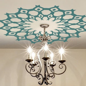 May include: A teal blue ceiling stencil with a geometric design. The stencil is applied to a white ceiling with a chandelier hanging below.