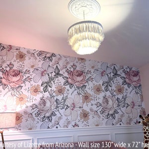 May include: A white floral wallpaper with pink and yellow flowers. The wallpaper is on a wall that is 130 inches wide and 72 inches high.