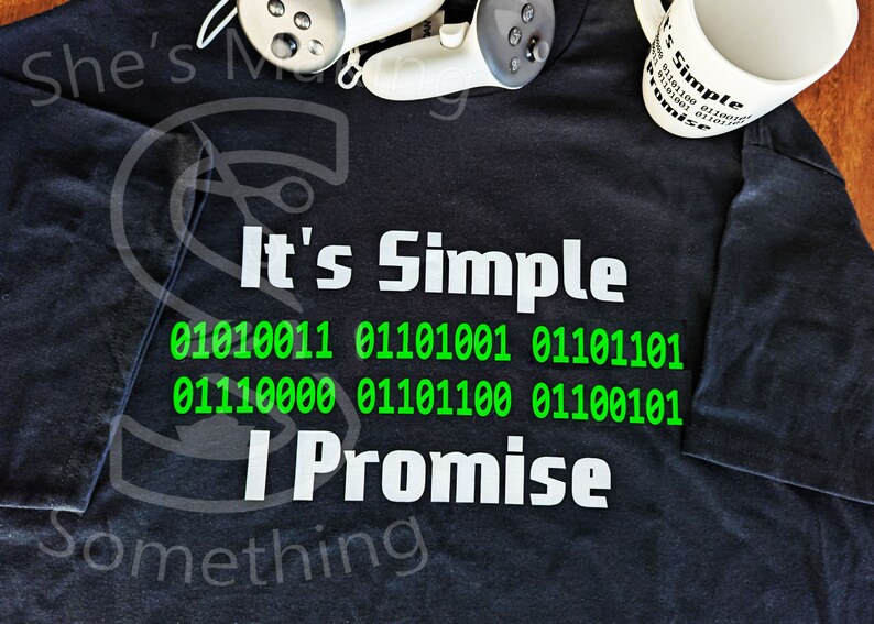 May include: A black t-shirt with white text that reads "It's Simple" and a line of binary code in green. The text "I Promise" is below the code. The words "Something" are at the bottom of the shirt.