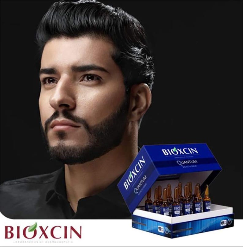 May include: A box of BIOXCIN Quantum Beauty Serum ampoules. The box is blue with white text and contains several small, brown glass vials. The BIOXCIN logo is visible at the bottom left. A man with dark hair and a beard is in the background.