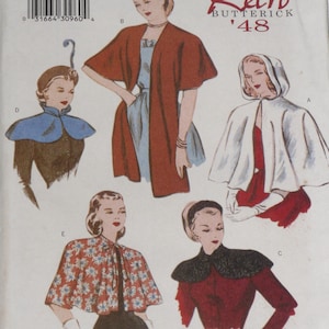 May include: Butterick 6411 sewing pattern envelope for sizes 6-8-10, featuring illustrations of five different garments: a blue collar, a rust-colored open jacket, a white hooded cape, a floral print capelet, and a black lace-trimmed collar.