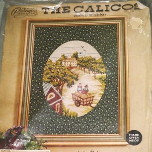 May include: A Paragon Needlecraft "The Calicos" creative crewel stitchery kit. The kit includes a framed oval picture of a rural scene with a house, trees, and people in a cart. The kit includes fabric, yarn, and instructions.