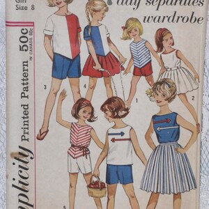May include: A vintage sewing pattern for a girl's 7-day separates wardrobe. The pattern includes a variety of tops, skirts, and shorts in red, white, and blue.