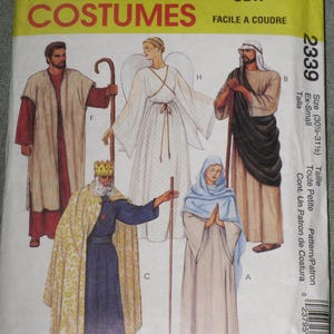 May include: A McCall's Costumes sewing pattern envelope, number 2339, size Ex-Small. The front features illustrations of five figures in historical or religious attire, including a king with a crown, an angel with wings, and three robed figures.