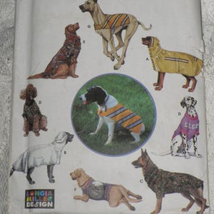 May include: A vintage sewing pattern featuring illustrations of various dog breeds wearing different types of apparel. The dogs are depicted in coats, vests, and rain gear. The pattern includes the text "LONGIA MILLER DESIGN".