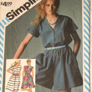 May include: A Simplicity sewing pattern envelope 6368 for a miss size 10 dress. The cover features a blue short-sleeved dress with a V-neck and a light blue belt. Two additional illustrations show a striped dress and a colorful patterned dress.