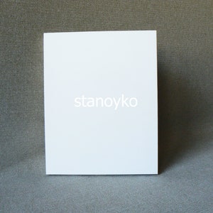 May include: A blank white card with the word "stanoyko" printed in the center.