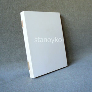 May include: A white blank canvas with the word "stanoyko" printed in black on the front.