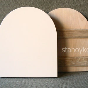 May include: Two wooden arched shapes, one painted white and the other with a natural wood finish. The natural wood shape has two horizontal wood strips across the center.