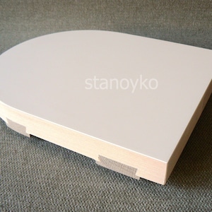 May include: White, rounded, wooden shelf with a smooth, flat surface. The shelf has a slightly curved edge and is supported by a wooden base.