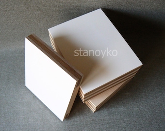 May include: Stack of four white, rectangular, wooden panels with a natural wood edge. The top panel has the word "stanoyko" printed in black.
