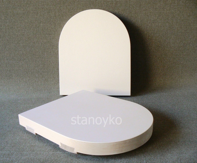 May include: Two white, round, wooden display stands. The top stand is arched and the bottom stand is flat. The bottom stand has the word "stanoyko" printed on it.