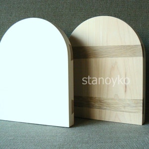 May include: Two arched wooden plaques, one white and one with natural wood grain and dark wood accents. The wood grain plaque has the text "stanoyko" printed on it.