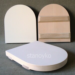 May include: Three wooden arched plaques, two with a white finish and one with a natural wood finish. The plaques have a rounded top and a flat bottom. The natural wood plaque has two horizontal wooden strips across the front. The text "stanoyko" is printed on the bottom of one of the white plaques.
