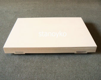May include: A white wooden platform with a smooth surface and rounded edges. The platform has two small wooden supports on each side.