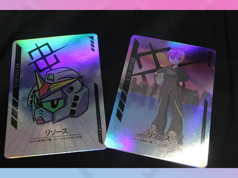 May include: Two holographic trading cards with Japanese text and illustrations. One card features a robot head, the other a character in a jumpsuit. Both cards have the word "RESOURCE" printed vertically.