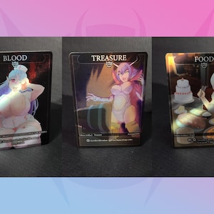 May include: Three fantasy art trading cards. The cards feature illustrations of anime-style characters labeled "Blood", "Treasure", and "Food". Each card has a dark border and text at the top. The characters are in various poses and settings.