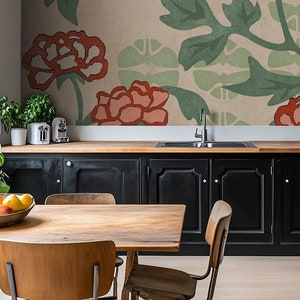 May include: A kitchen with black cabinets and a floral wallpaper mural. The wallpaper features a repeating pattern of red and green flowers. A wooden table with chairs is in the foreground.