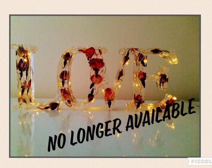 Beautiful resin love sign with real rosebuds and fairy lights in soft white