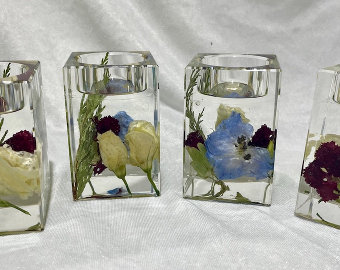 Tea light memorial candle holders with dried funeral flowers.